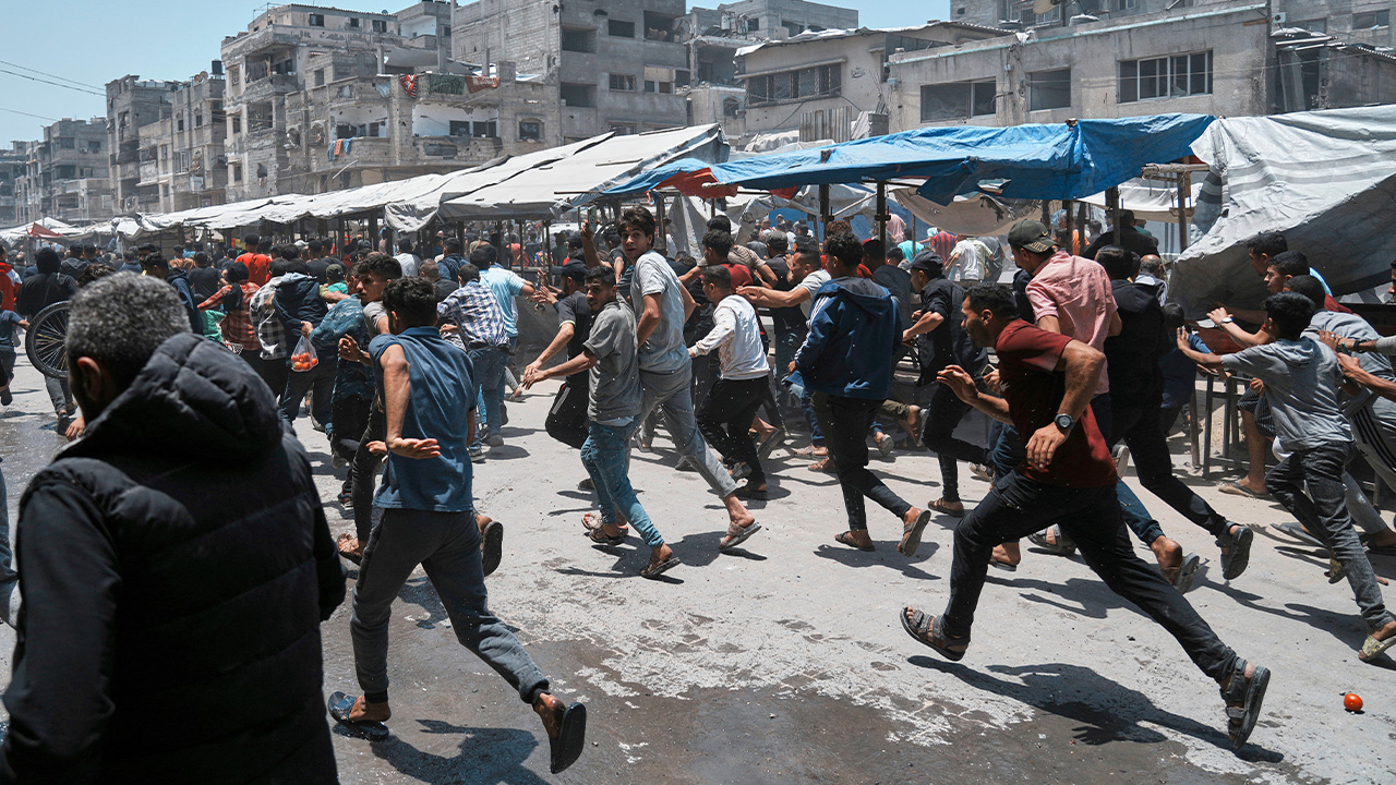 Palestinians run following an Israeli strike in Gaza City, Sunday, June 1, 2025.