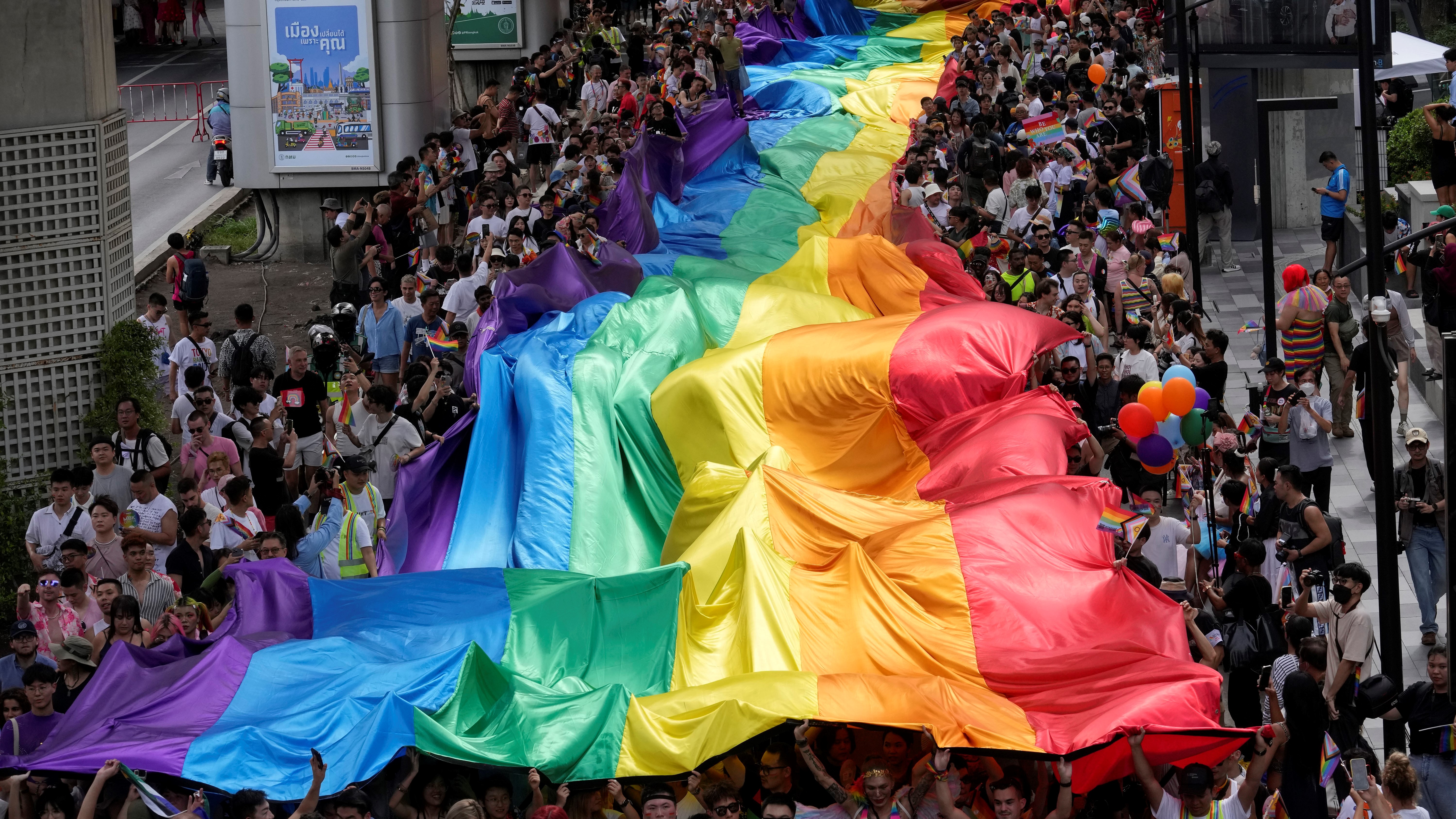 Participants hold a rainbow flag during the Pride Parade in Bangkok, Thailand, Saturday, June 1, 2024.