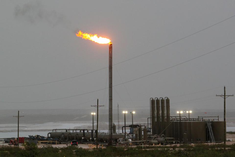 Strong winds kick up dust as a facility in the Permian Basin flares natural gas east of Carlsbad, N.M., on Monday, May 19, 2025 (AP)