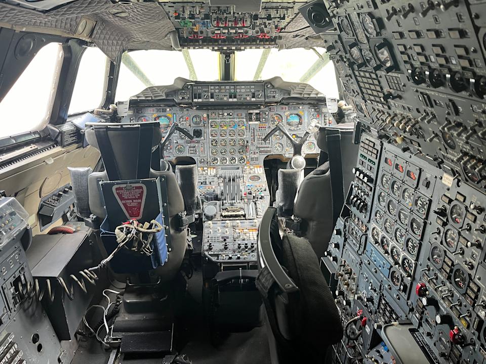 The cockpit of a plane, with countless dials and switches.
