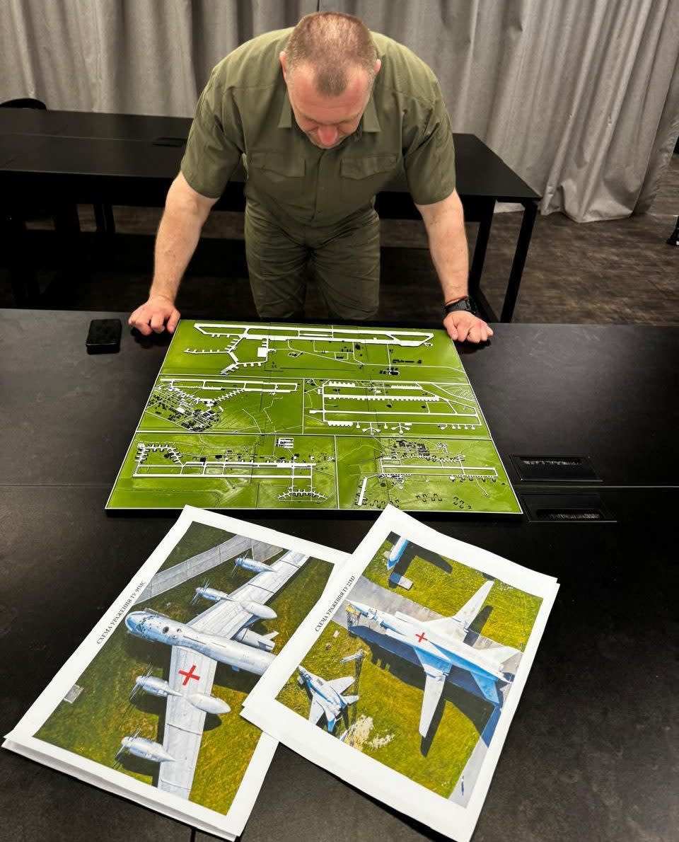 Vasyl Malyuk, head of Ukraine's security service, looking at a map showing a Russian military aircraft base