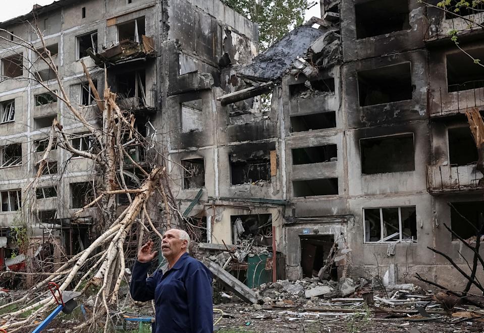 A resident gestures as he stands near buildings damaged by Russian military strikes, amid Russia's attack on Ukraine, in the frontline town of Myrnohrad, Donetsk region, Ukraine May 29, 2025.