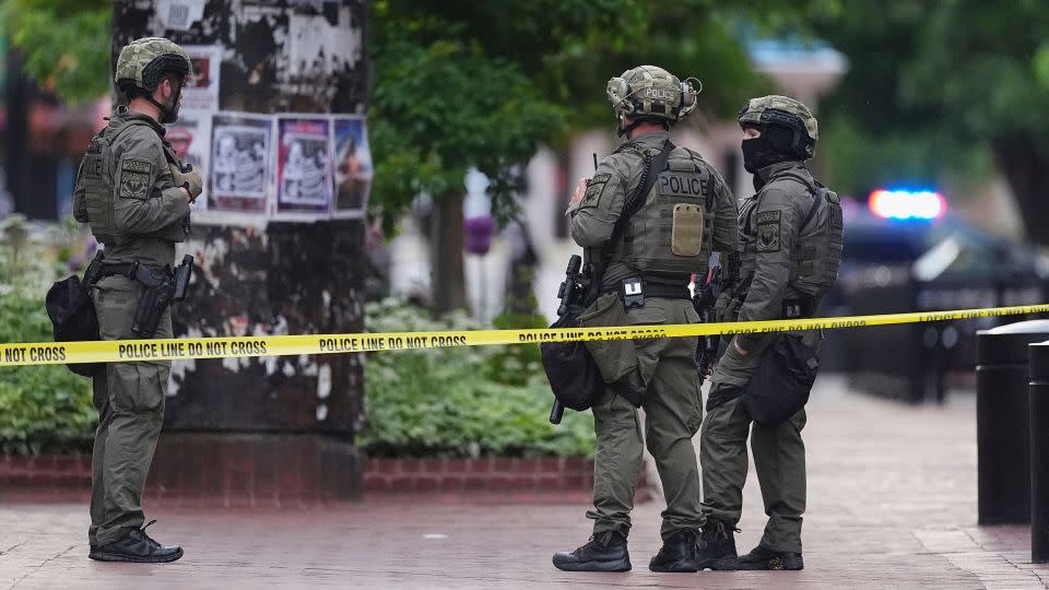 Law enforcement officials investigate after an attack on the Pearl Street Mall, on Sunday in Boulder, Colorado. - David Zalubowski/AP