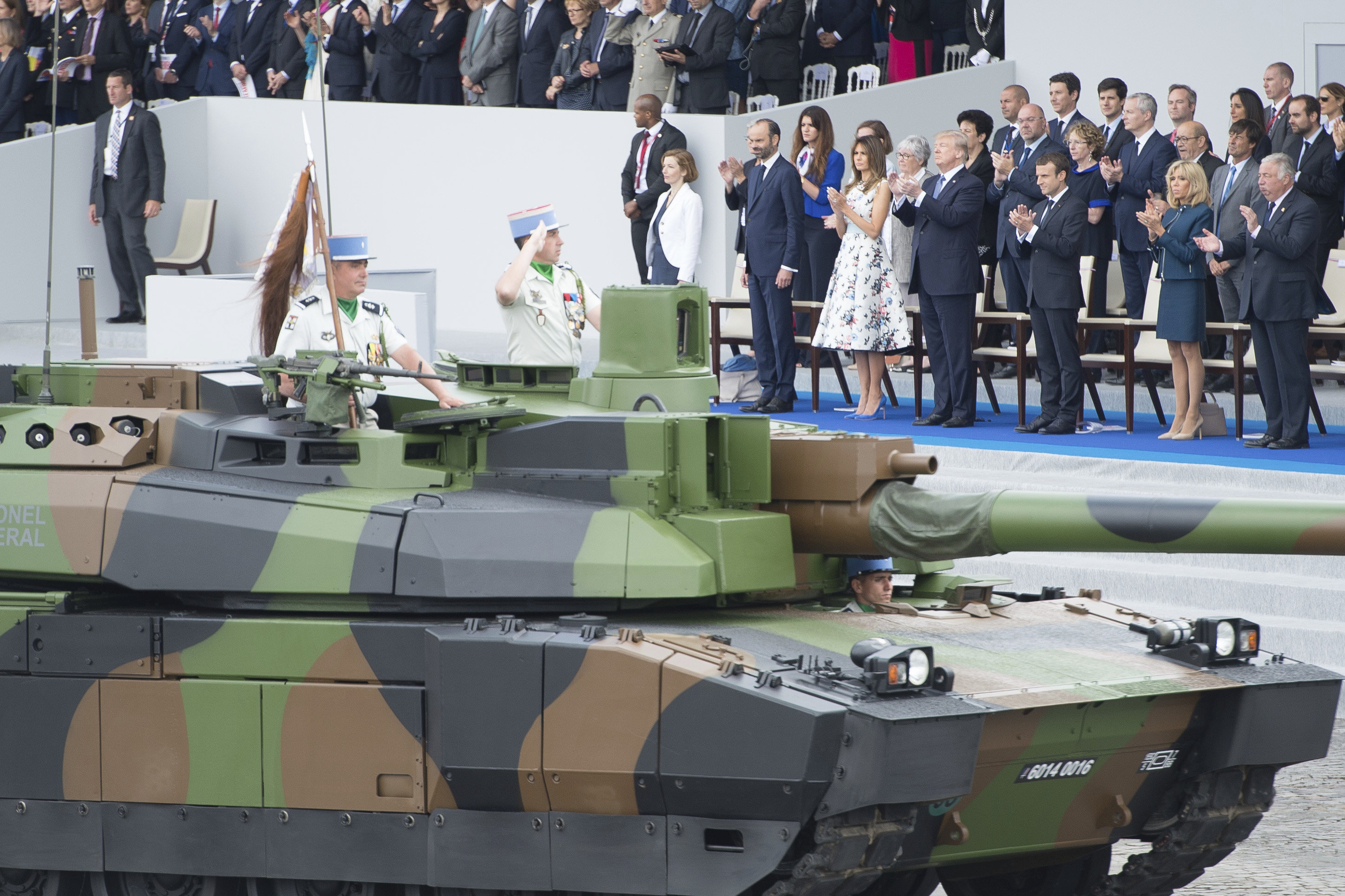 US President Donald Trump (2nd L) salutes as French President Emmanuel Macron (2nd R) his wife Brigitte Macron (R) and US First Lady Melania Trump (L) watch the annual Bastille Day military parade on the Champs-Elysees avenue in Paris on July 14, 2017. The parade on Paris's Champs-Elysees will commemorate the centenary of the US entering WWI and will feature horses, helicopters, planes and troops. Photo by Eliot Blondet/Sipa USA(Sipa via AP Images)