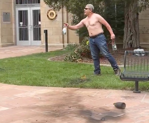 This video still shows a man identified by police as Mohamed Sabry Soliman holding Molotov cocktails in front of the Boulder County Courthouse on the Pearl Street Mall in Boulder on Sunday, June 1, 2025. (Video still via Brian Horwitz)