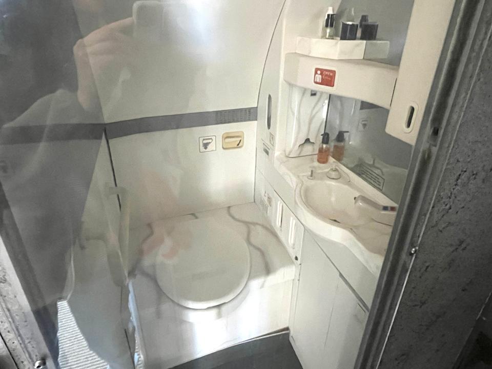A plane bathroom behind glass.