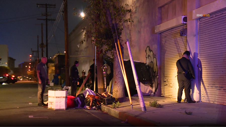 The suspect of a fatal double-machete stabbing is seen under arrest in downtown Los Angeles. June 2025. (RMG News)