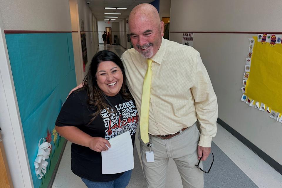 Superintendent Lee White shares a hug with teacher Vanessa Calderon in the hall of the elementary school in Loving, N.M., on Monday, May 19, 2025 (AP)