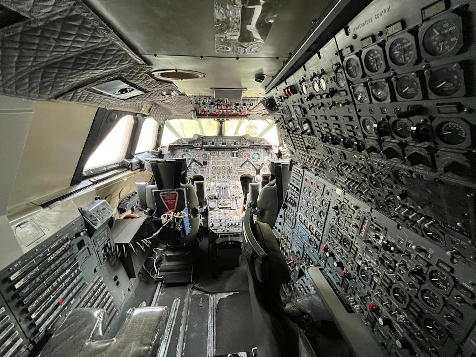 The cockpit of a plane with countless dials and switches.
