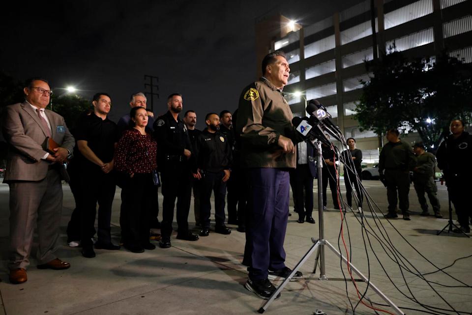 LA County Sheriff Robert Luna speaks at a news conference after dark.